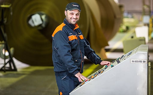 Male production worker next to the controlling machine