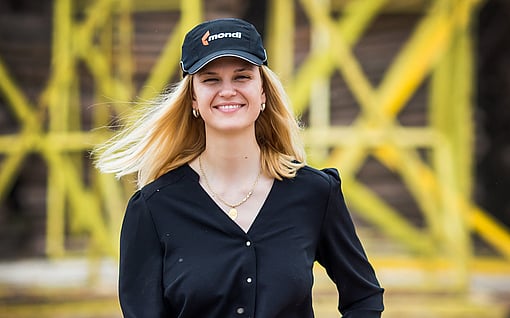 woman with Mondi cap holding security helmet